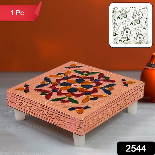 Close-up of the intricate Meenakari hand painting on a traditional wooden chowki.