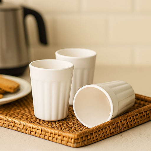 Set of three reusable plastic coffee and tea cups for daily use.