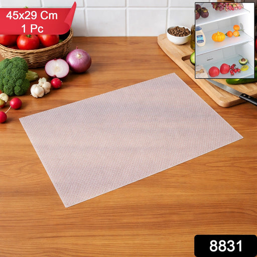 Refrigerator shelf lined with transparent plastic refrigerator mat and organised food items