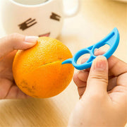 A bright orange being peeled with the Snail Orange Peeler, highlighting its mess-free capability.