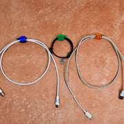 Multiple hand shape wall clips demonstrating their use for organizing small household items.