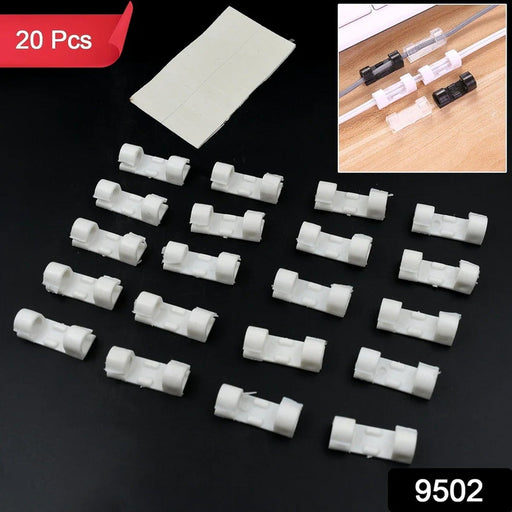 Multiple plastic cable clips neatly organizing various wires along a wall, creating a tidy workspace.