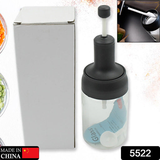 Clear glass condiment jar with spoon and lid, showcasing its versatile design.
