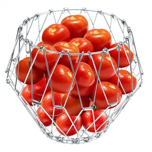 Elegant stainless steel wire foldable fruit basket displayed on a kitchen counter.