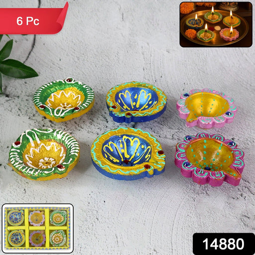 Close-up of decorative clay diyas with intricate traditional painting