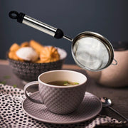 Fine mesh stainless steel strainer ready to filter juice or tea.