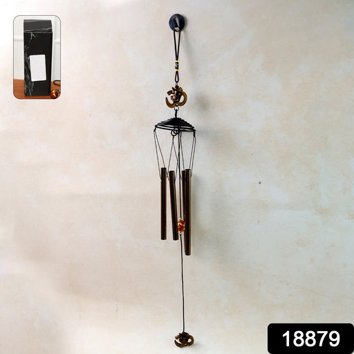 Close-up of metal wind chime with Om symbol showing tuned metal tubes