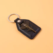 Close-up of decorative vintage style aircraft emblem on leather finish keychain