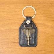 Lifestyle image of aircraft design keychain next to keys and accessories