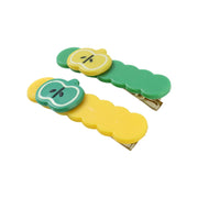Side view of colorful apple design hair clip holding hair gently