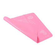 Compactly rolled-up silicone baking mat for easy storage and portability.