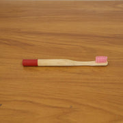 Lifestyle image of bamboo toothbrush in bathroom setting