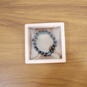 Lifestyle image of wrist wearing crystal beaded dual-tone stretch bracelet