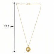 angled view of golden necklace chain and intricate pendant