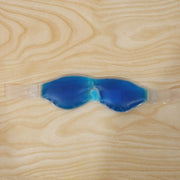 Person wearing a blue cooling gel eye mask for daily use