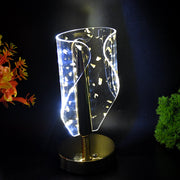 Close-up of crystal acrylic shade with golden leaf patterns on table lamp
