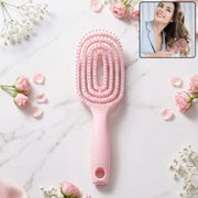 Pink curved vented detangling hair brush designed for effortless hairstyling