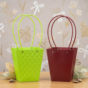 Close-up of curved handle and snap-button detail on flower bag