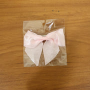 Model wearing satin hair bow clip showcasing stylish hair accessory
