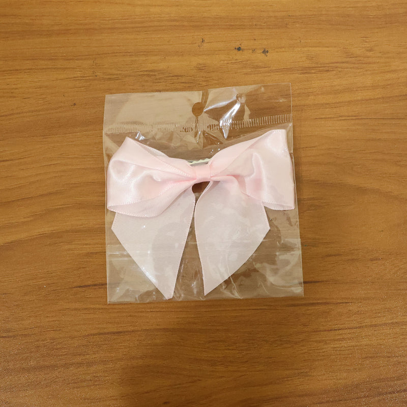 Model wearing satin hair bow clip showcasing stylish hair accessory