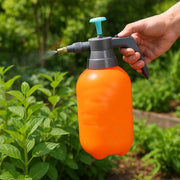 Close-up of the pump handle and spray nozzle on the garden pressure sprayer.