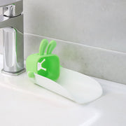 Hand demonstrating the flexible, durable silicone material of the faucet extender.