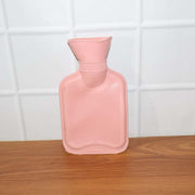 Small hot water bag in use for warm compress and pain comfort