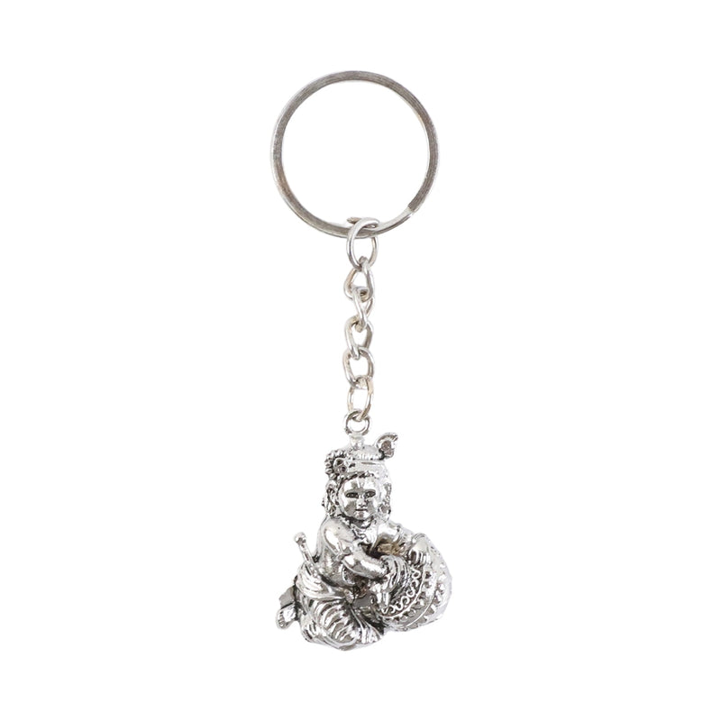 Bal Krishna Makhan Chor keychain displayed against a wooden backdrop