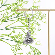 Angled view highlighting silver finish on Bal Krishna Makhan Chor metal keychain