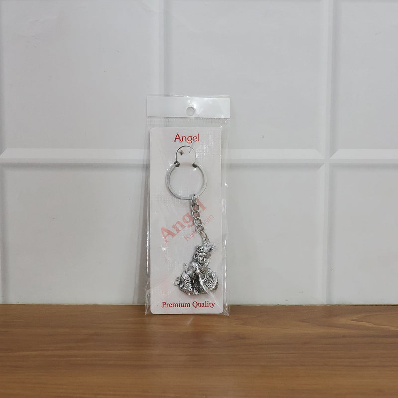 Bal Krishna Makhan Chor keychain attached to vehicle keys adding a spiritual charm