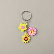 Flower smiley face cartoon keychain showcasing metal ring attachment