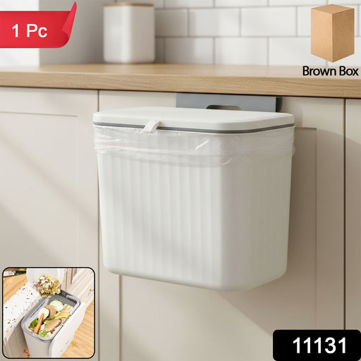 Plastic kitchen dustbin with lid mounted on the wall