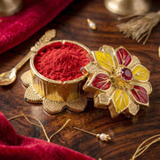 Close-up of ornate golden pooja kumkum box