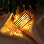 Close-up of a flickering LED flameless candle with ribbed design