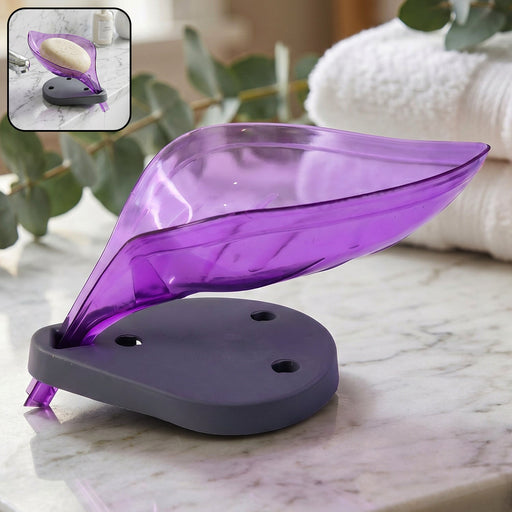 Stylish leaf shape soap tray with drain on a modern bathroom counter.