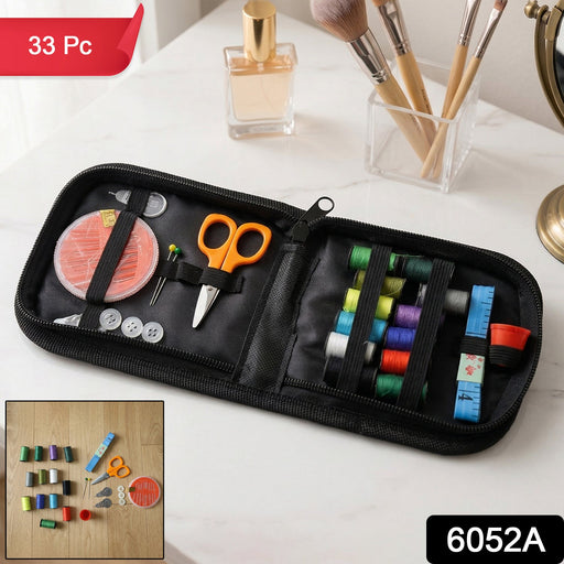 Open portable stitching kit revealing various threads, needles, and tools for travel.