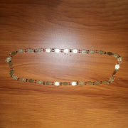 Traditional statement gold tone coin necklace worn with ethnic outfit
