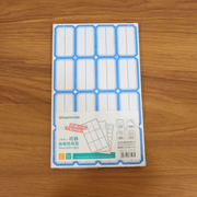 Hand applying writable label sticker to a folder for clear identification