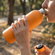 Orange insulated hydration water bottle made of stainless steel