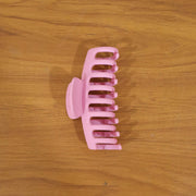 Model wearing elegant pink hair claw clip in styling