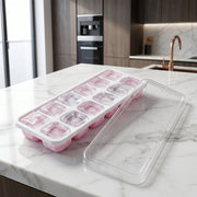 Side view of pink ice cube tray with lid