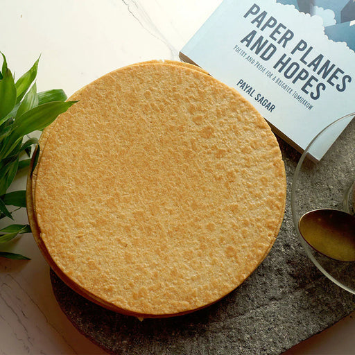 Stack of golden-brown Plain Khakhra, highlighting its thin, crunchy texture.