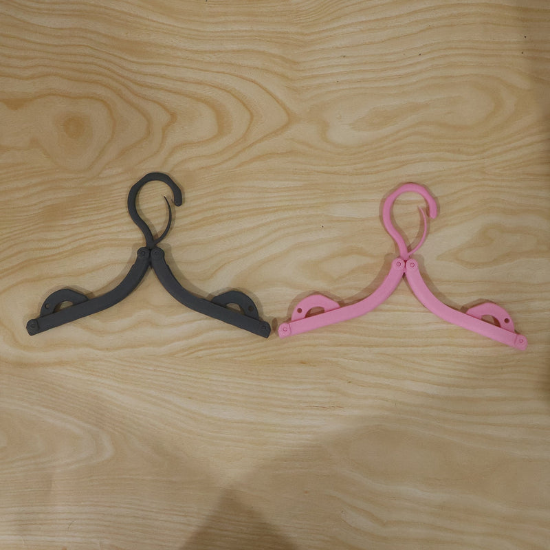 Bright colored foldable hanger designed for organizing wardrobe efficiently