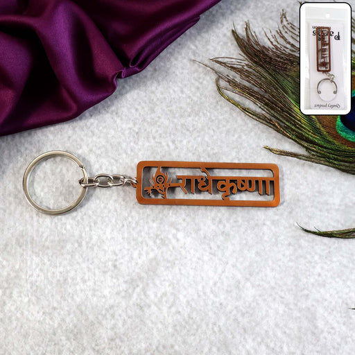 Radha Krishna Metal Keychain with laser-cut Hindi inscription and peacock feather motif