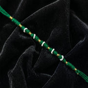 Close-up of green pearl beaded rakhi design