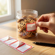 Red and white self-adhesive label stickers displayed on white background