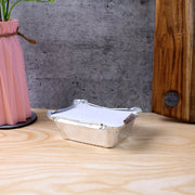 Open disposable aluminium container showing interior space for food
