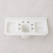 Side profile of the plastic soap dish holding a bar of soap, demonstrating its practical use.