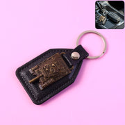 Leather finish keychain featuring a metal military tank design emblem