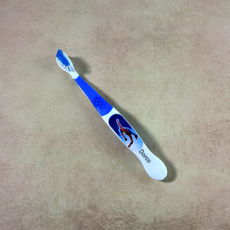 Children’s toothbrush with soft bristles and colorful cartoon design